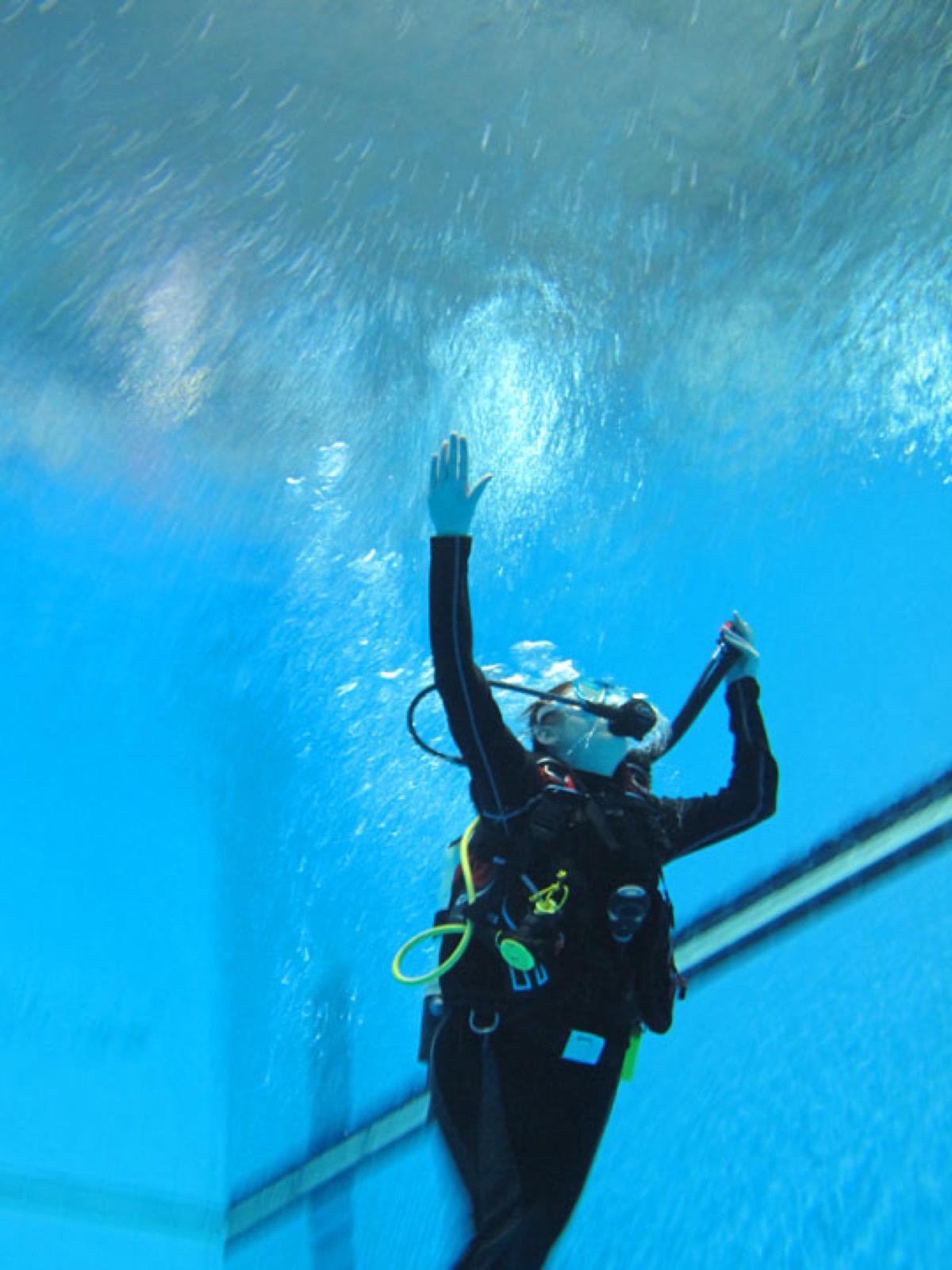 A diver ascending through clear water